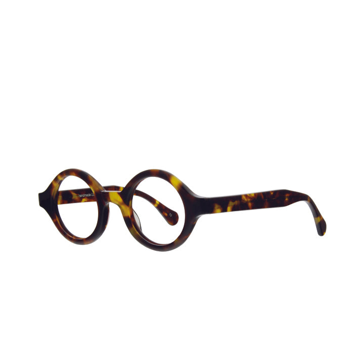 Angled view of thick round full frame eyeglasses with a tortoise patterned color and clear lenses.