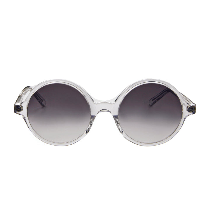 A pair of round full frame sunglasses made of acetate, in a crystal clear color, with gradient gray lenses.