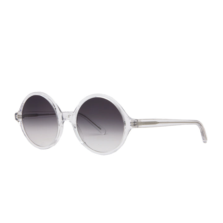 A pair of round full frame sunglasses made of acetate, in a crystal clear color, with gradient gray lenses.