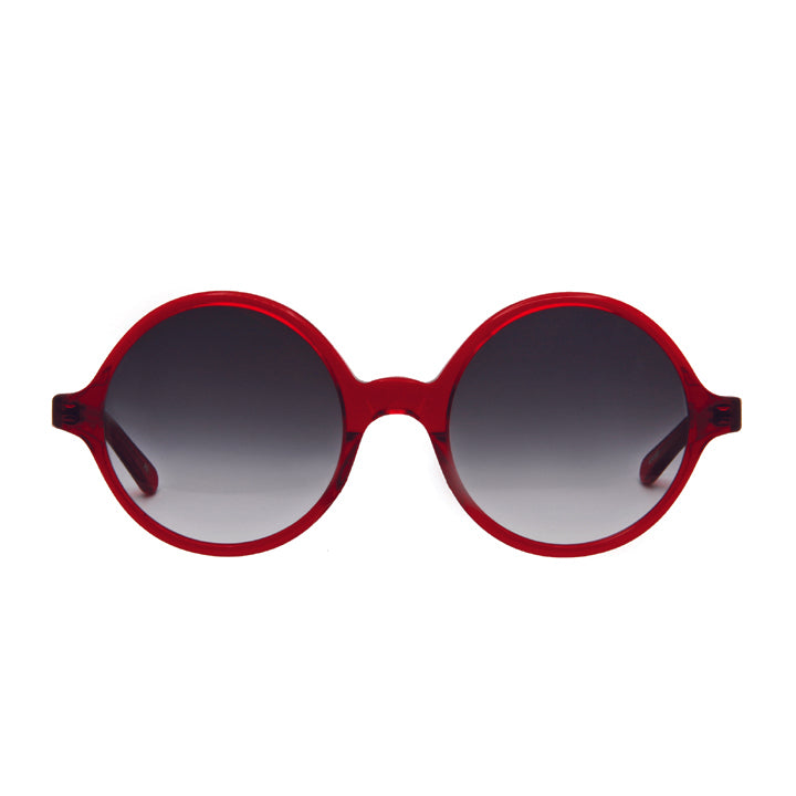 A pair of perfectly round full frame large sunglasses with saddle bridge, featuring gray lenses in translucent red color.