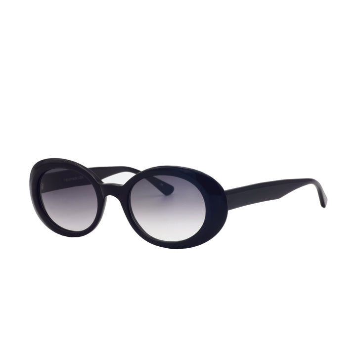 A pair of large rounded sunglasses with saddle bridge, featuring gray lenses in black.