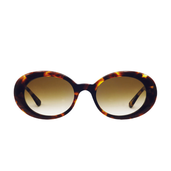 A pair of large rounded sunglasses with saddle bridge, featuring brown lenses in tortoise pattern.